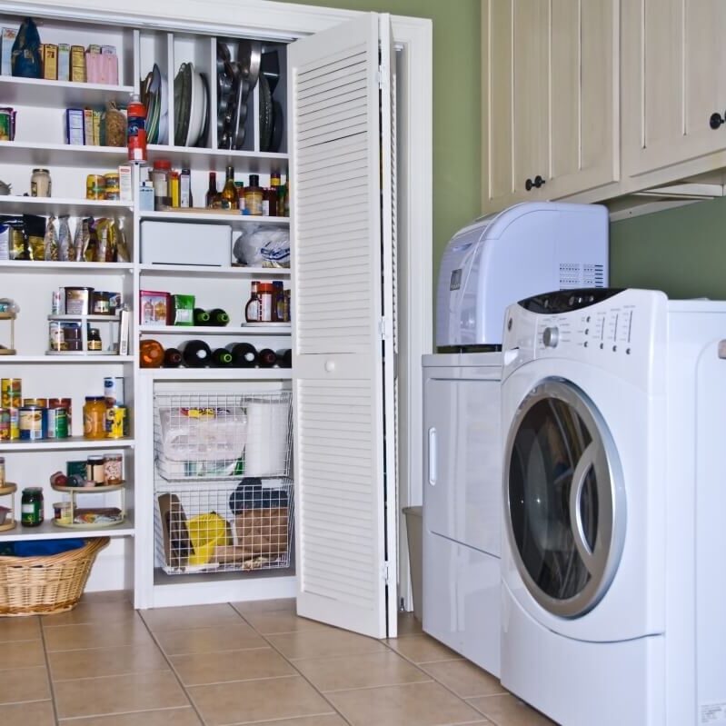 A laundry room with pantry shelf area.